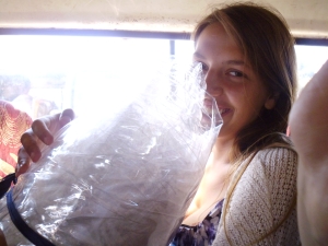 Emily squished in a matatu (public minivan) with 20m of plastic sheet